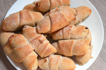Homemade pastry. The rugelach with jam in a plate. Homemade holiday cookie.