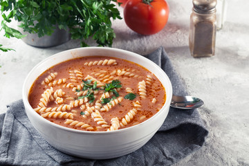 Tomato soup with fusilli pasta in the bowl