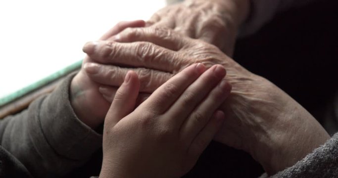 children's hands stroke tired old hands with deep wrinkles and veins. Caring for the elderly. continuity of generations. love your loved ones.
