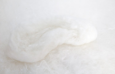 White silkworm threads as background.