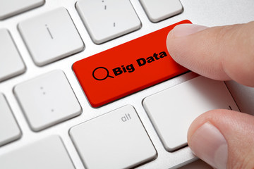 White computer keyboard and red button against big data background.Male hand pressing big data...