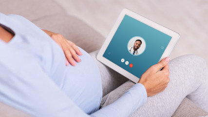 Woman having video chat with male doctor using tablet