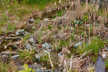 The problem of pollution and ecology of reservoirs. Garbage on the shoreline in the city limits