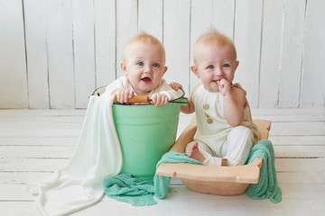Children's Day. Sweet funny baby on bed in children room. Greeting card, copyspace for your text. Poster for spring and summer holiday. Congratulations on Mother's Day. Cute baby twin boys