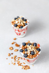 Granola Parfait with greek yogurt, oat cereal, fresh berries, honey in glass jar