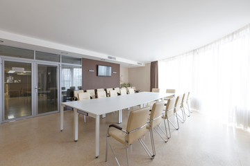 Meeting room with big glass door and table