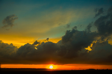 Sunset on the field. Beautiful sunset landscape with large field and a forest on background