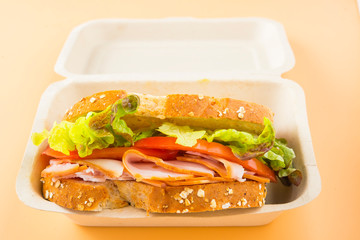 Sandwich of tomato, lettuce and smoked turkey