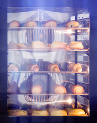 Baking tray with delicious croissants in oven