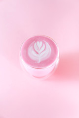 Obraz na płótnie Canvas matcha latte with rosetta art on pink background copy space