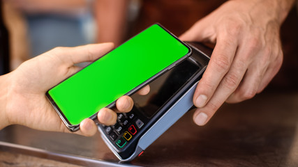 Young Woman is Using Her Smartphone with Green Screen for Contactless Payment. She is Paying for Gourme Street Food. Eco Friendly Gluten Free Food Court Selling Modern Fusion Cuisine