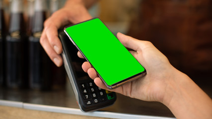 Young Woman is Using Her Smartphone with Green Screen for Contactless Payment. She is Paying for Gourme Street Food. Eco Friendly Gluten Free Food Court Selling Modern Fusion Cuisine