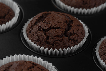 chocolate cupcakes on wooden background