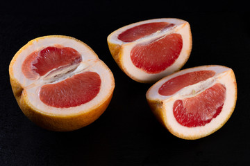 red grapefruit on a black background