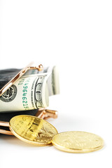 An open black wallet with money, dollars and bitcoin coins on a white background.