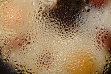 Drops of water on a hot glass lid, condensate background