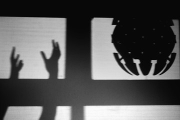 A shadow like an alien spaceship, monochrome. Kidnapping and UFO silhouette in the window, black and white concept