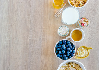 Healthy breakfast set with coffee, granola, nuts, honey or agave syrup and fruits. 