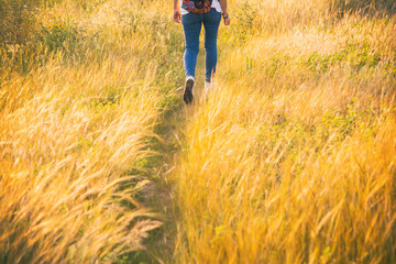 Unrecognizable Woman Walking Across The Field. Beautiful Landscape Of Nature In Extremadura With Its Colors And Wild Flowers. Lifestyle.