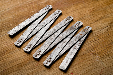 Measuring iron folding meter old, photographed on a shabby wooden surface.