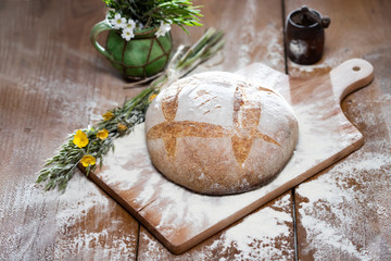 Freshly baked traditional bread on wooden table