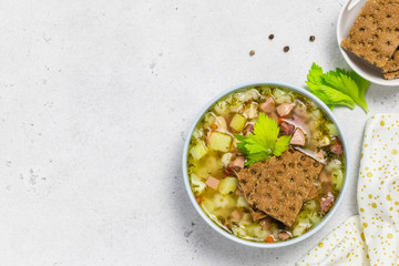 Spicy sausage soup with crisp bread.Top view, copy space.