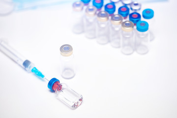 Close up on vaccine and medical syringe