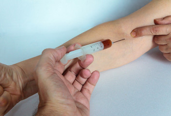 doctor holding syringe