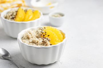 Healthy breakfast, citrus almond milk oats. Selective focus, copy space.