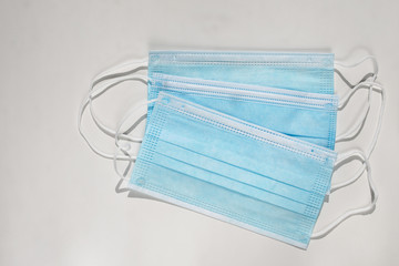 Blue antibacterial medical masks on a white background