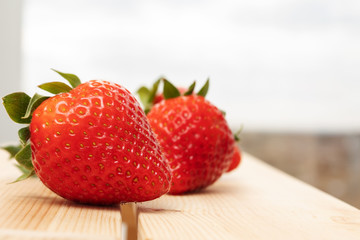 Early summer. Ripe juicy sweet strawberries on a wooden background