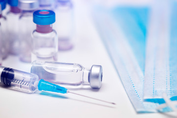 Close up on vaccine and medical syringe