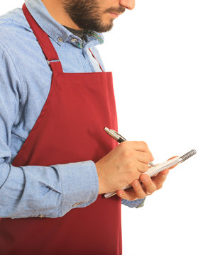 Waiter With Red Apron Writes An Order Standing On White Background