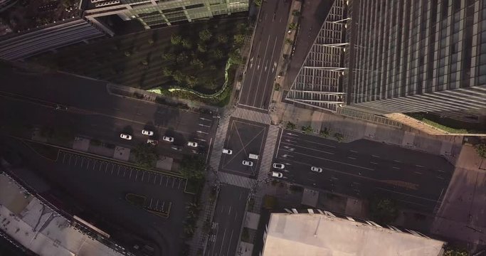 Orbit aerial flight rotating above urban city's intersection. Drone, 4K.