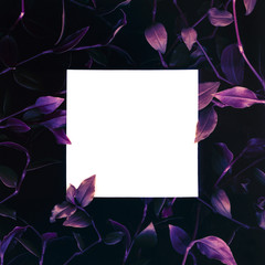 Creative layout made of green leaves with paper card mock up. Flat lay. Template for invitation, banner, business card, greeting card