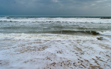 Sunshine pouring over the sea  through the clouds view from beach of somnath temple Gujarat India
