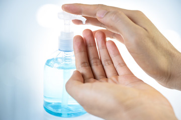 Man using hand sanitizer wash gel pump dispenser for protection coronavirus (covid-19) and germ, health care concept