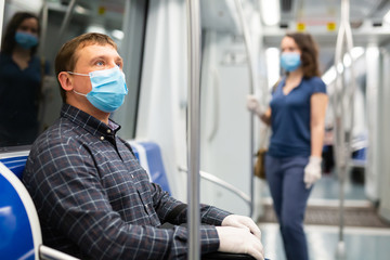 Man in disposable mask in subway train © JackF