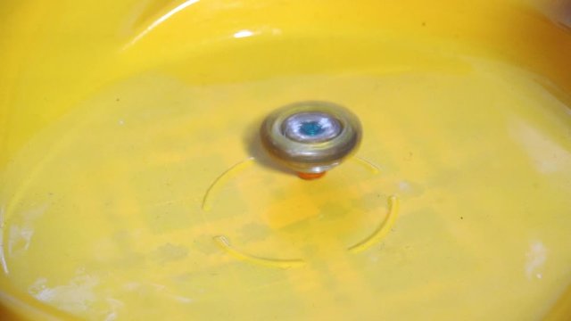 Collective image of the children's popular toy Beyblade. The battle of two Beyblade in the arena in a flat style.Slow motion.
