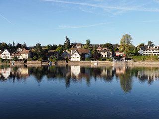 Fototapeta na wymiar Houses reflected in Rhine River in STEIN am RHEIN town in Switzerland