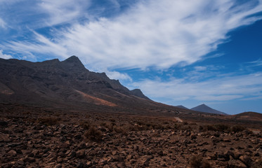 Scenic panorama with mountain range and Cofete beach (Playa de Cofete) at Fuerteventura, Canary Islands, Spain. October 2019