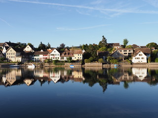 Fototapeta na wymiar Buildings reflected in Rhine River in STEIN am RHEIN in Switzerland