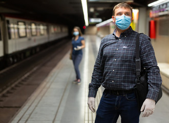 Man in medical mask on subway platform