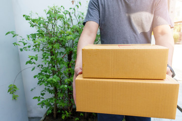 Close up man is holding delivery box at home
