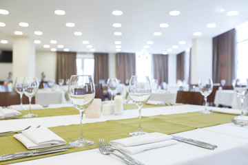 Empty stylish table in restaurant with glasses