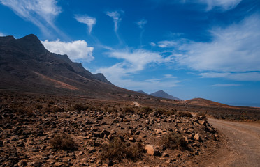 Scenic panorama with mountain range and Cofete beach (Playa de Cofete) at Fuerteventura, Canary Islands, Spain. October 2019