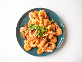 Baked Shrimp Whole shell with salt, frogs, garlic for fragrance Garnish with spring onions and coriander on a round dish,White background