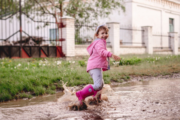 child run through a puddle