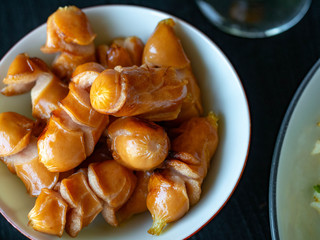 Fried chicken sausage on a white cup
Is a fast appetizer with high energy.