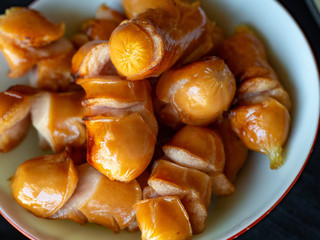 Fried chicken sausage on a white cup
Is a fast appetizer with high energy.